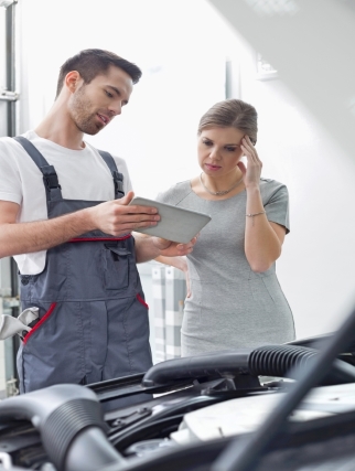 Certified mechanic explaining service to customer